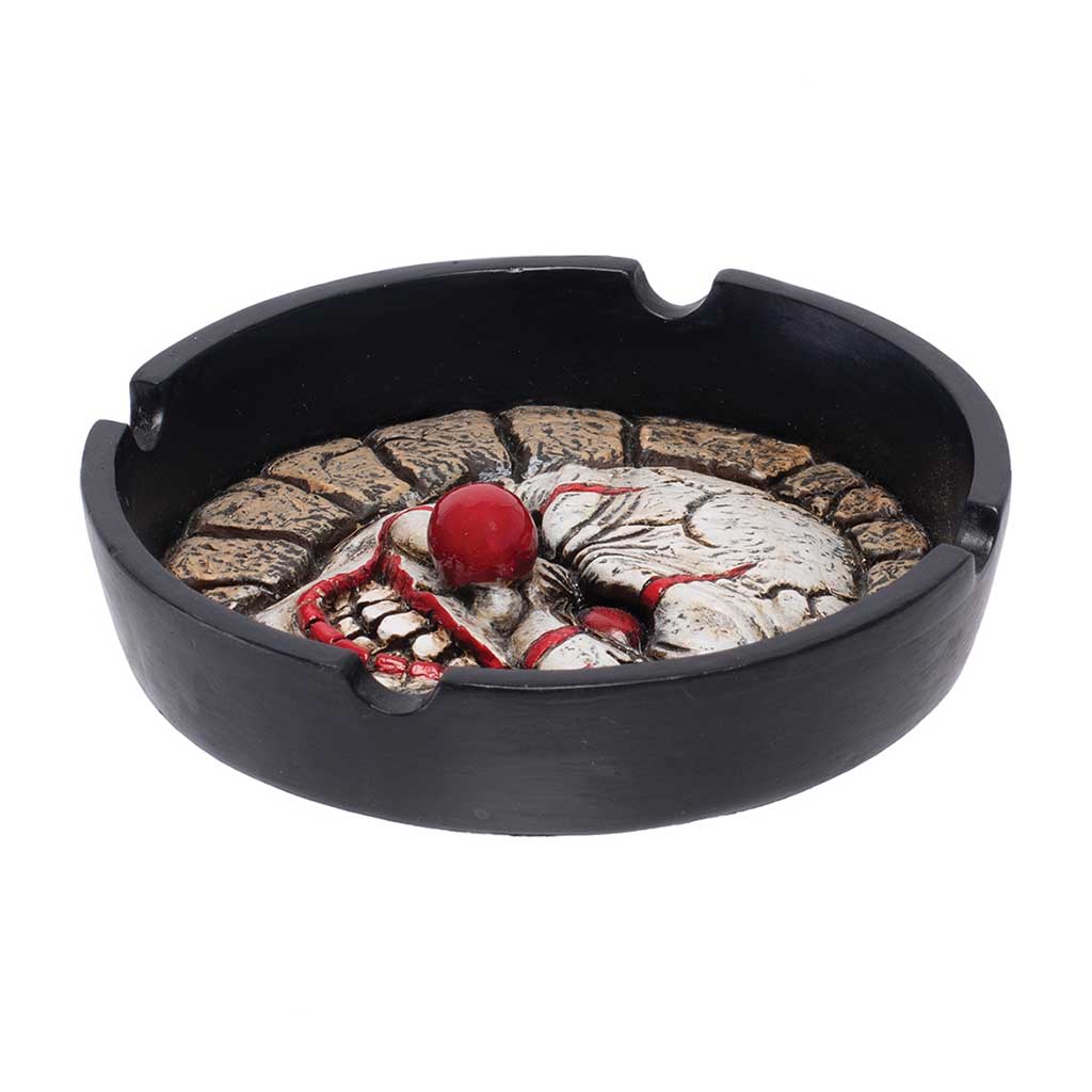 Side view of the Scary Clown Ashtray showing the raised clown face and a notched, round rim