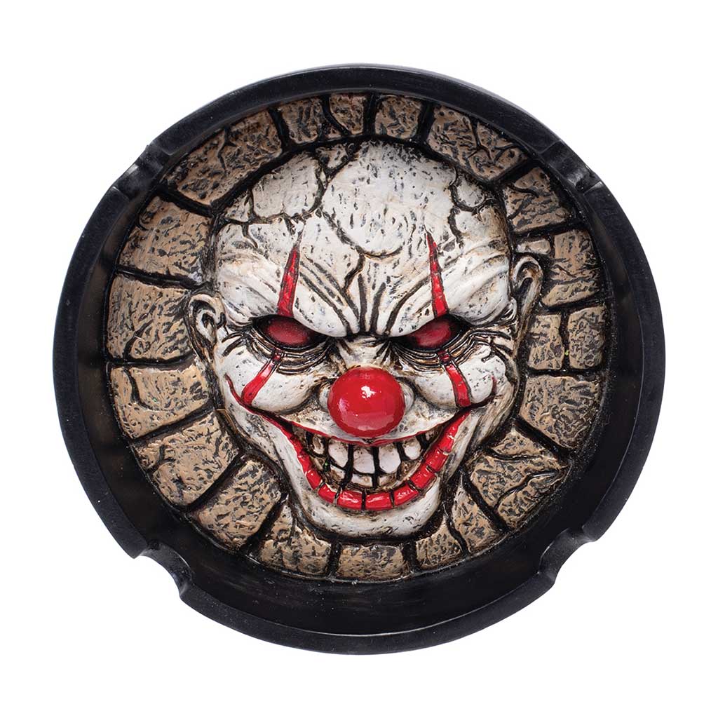 Scary Clown Ashtray in black resin shown from above with a 3D face and two rim notches