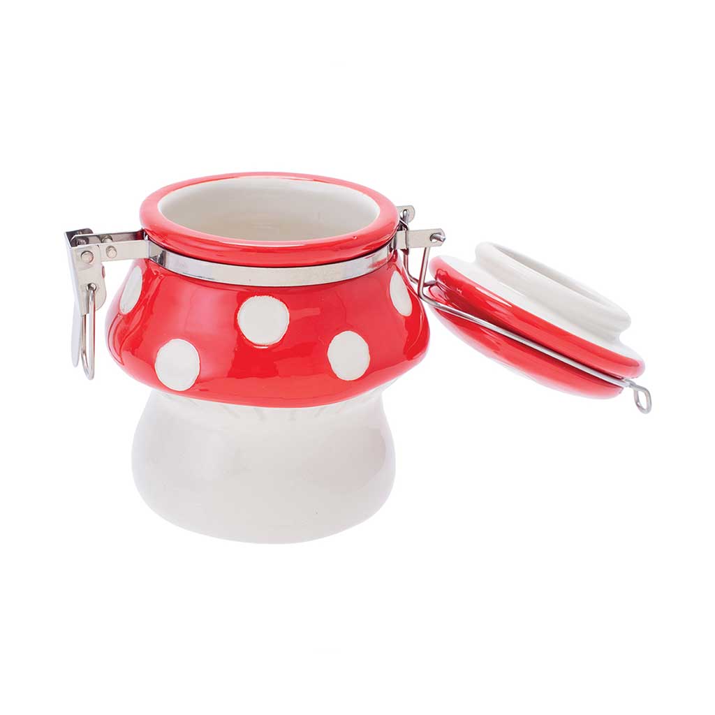 Red mushroom ceramic jar open with clasp lifted and lid tilted back.