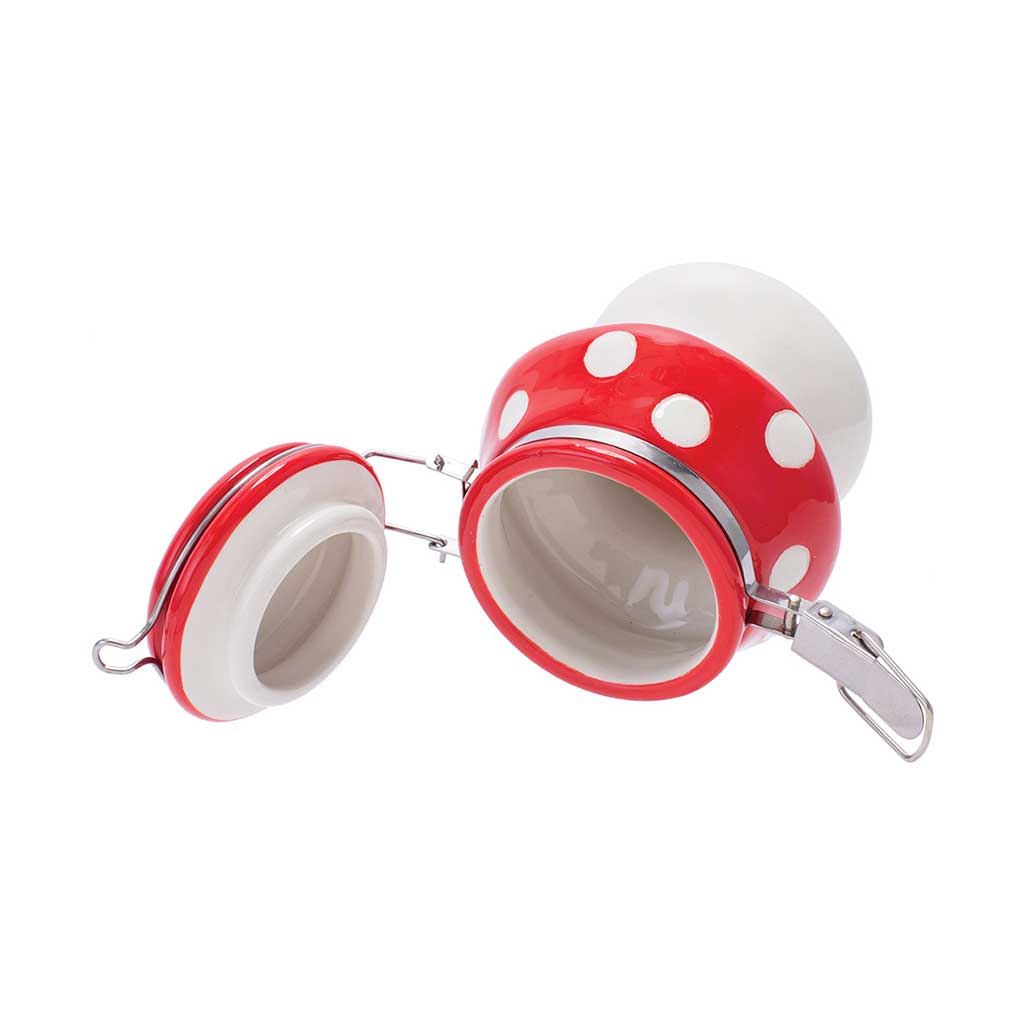 Side view of the red mushroom ceramic stash jar side views, showing the cap and spots. 