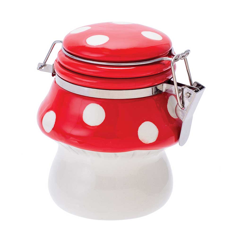 Red mushroom ceramic jar with white spots and a metal clasp, front view.
