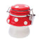 Red mushroom ceramic jar with white spots and a metal clasp, front view.