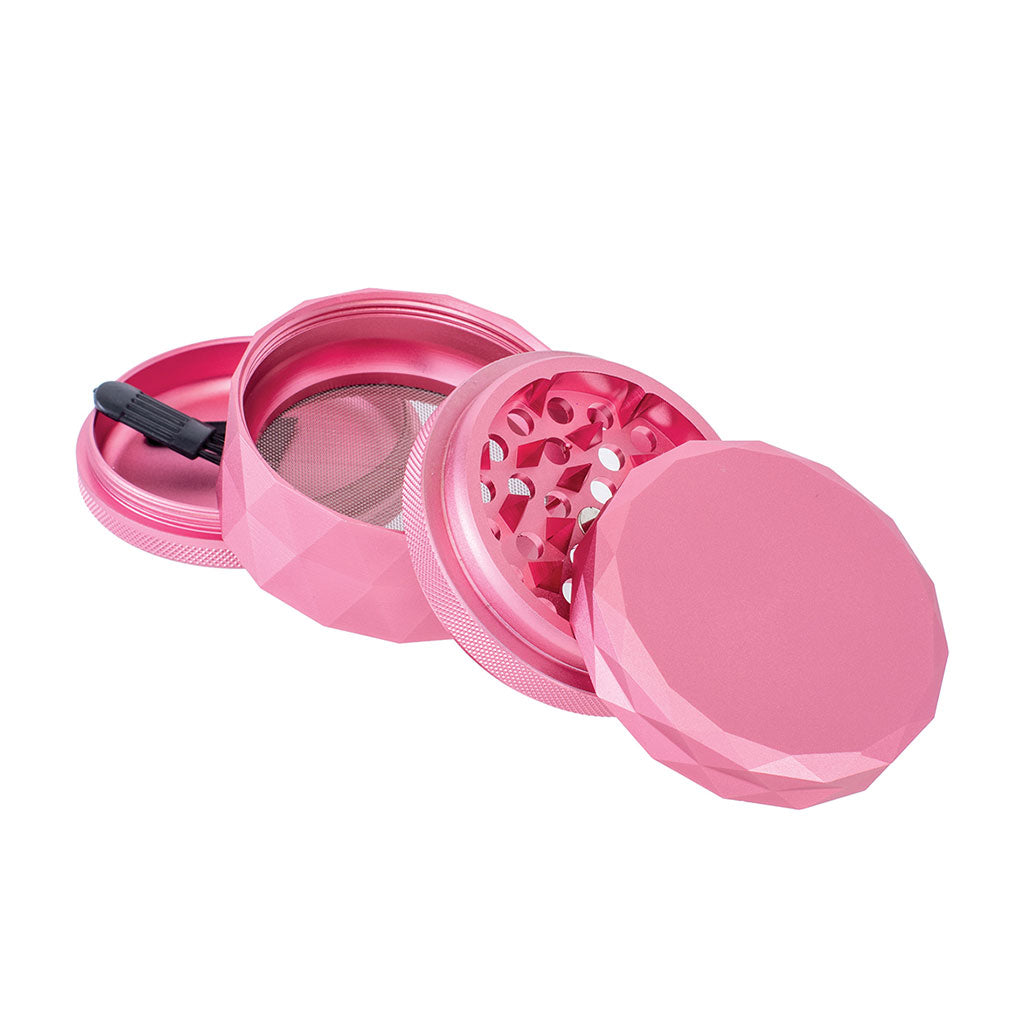 4-piece Pink Harlequin Grinder showing sharp blades, mesh sifter, and kief catcher for precise herb prep