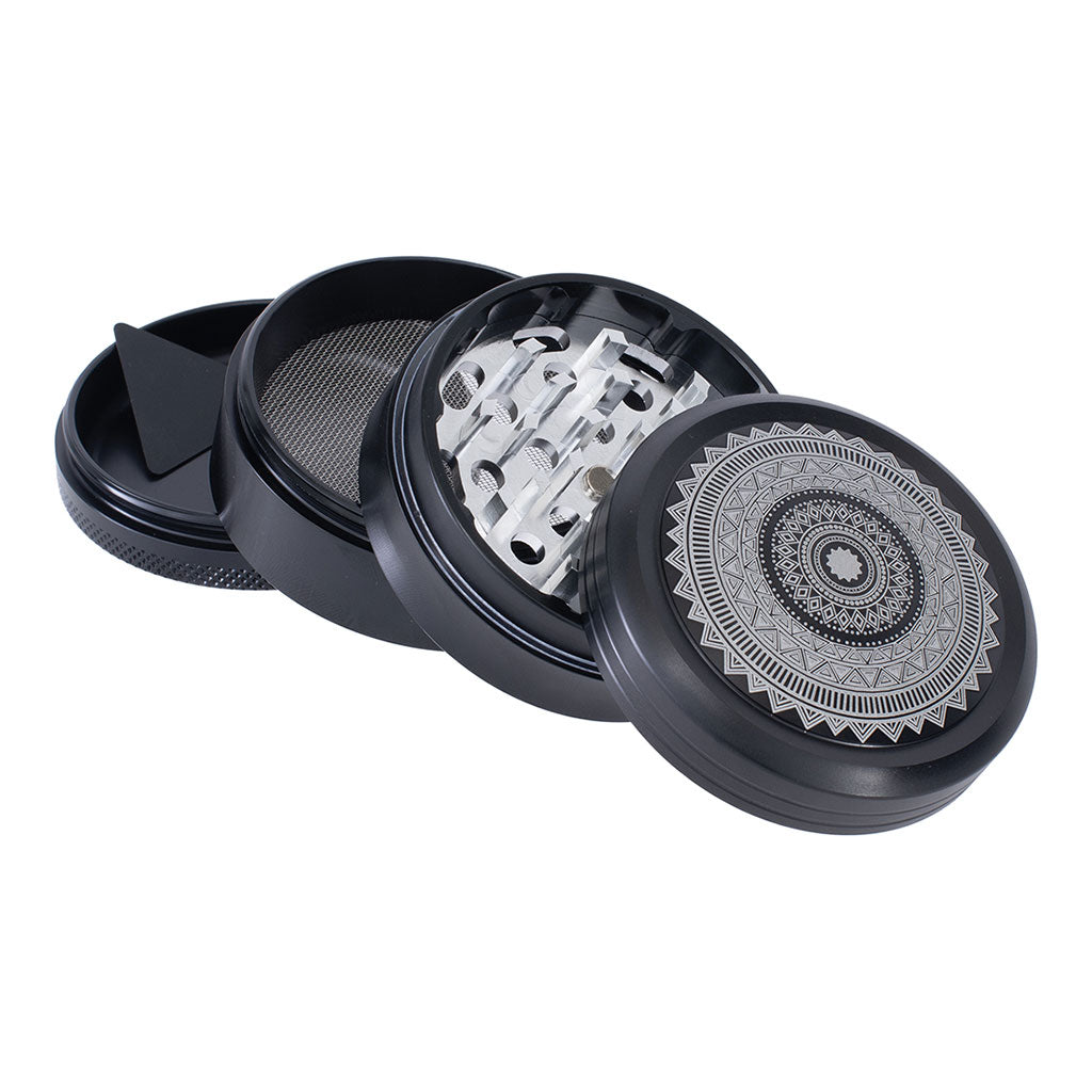 Disassembled Black Mandala grinder showing kief catcher and sharp teeth