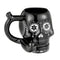 Black Skull Premium Roast and Toast pipe mug with glossy black finish, white floral skull artwork, built-in front bowl, and curved handle