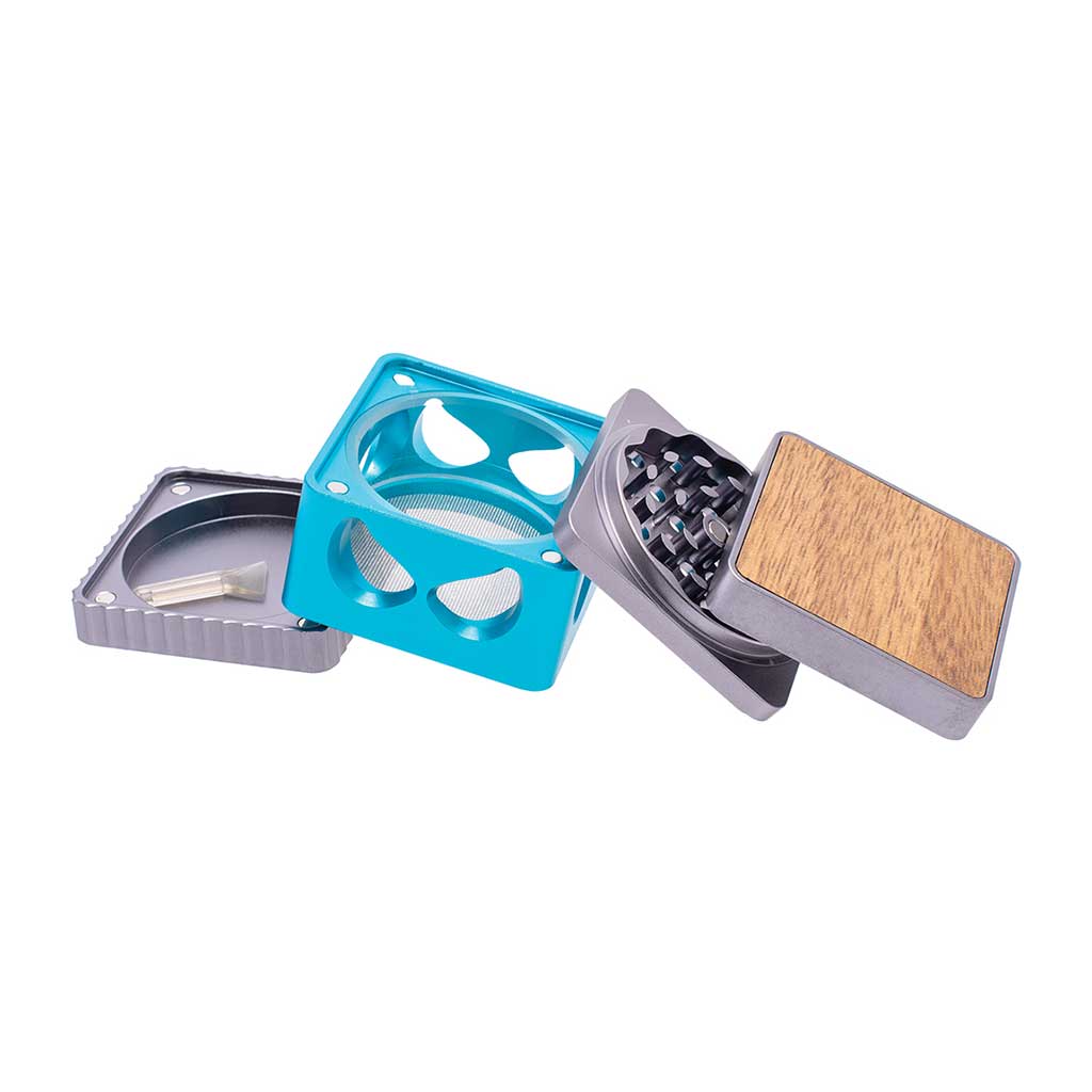 Blue square Harlequin grinder fully disassembled showing all parts including sifter, scraper, and sharp grinder blades