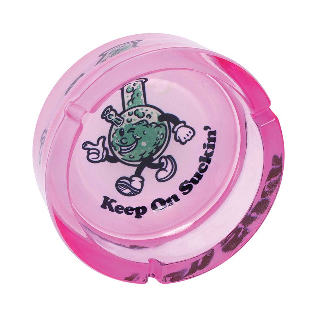 Top View Of Pink Glass Ashtray Featuring Cartoon Bong Character And Text “Keep On Suckin’”
