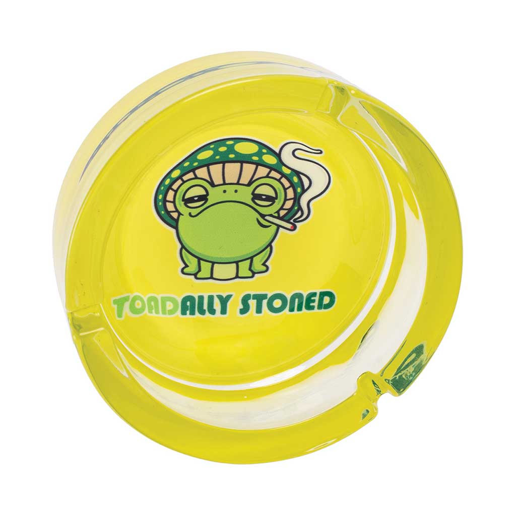 Top View Of Bright Yellow Glass Ashtray With Cartoon Toad Smoking And Text “Toadally Stoned”