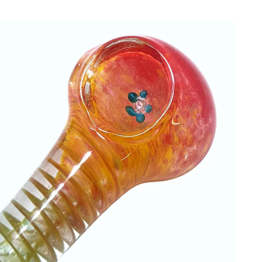 Closeup of flower design glass screen inside hand pipe bowl