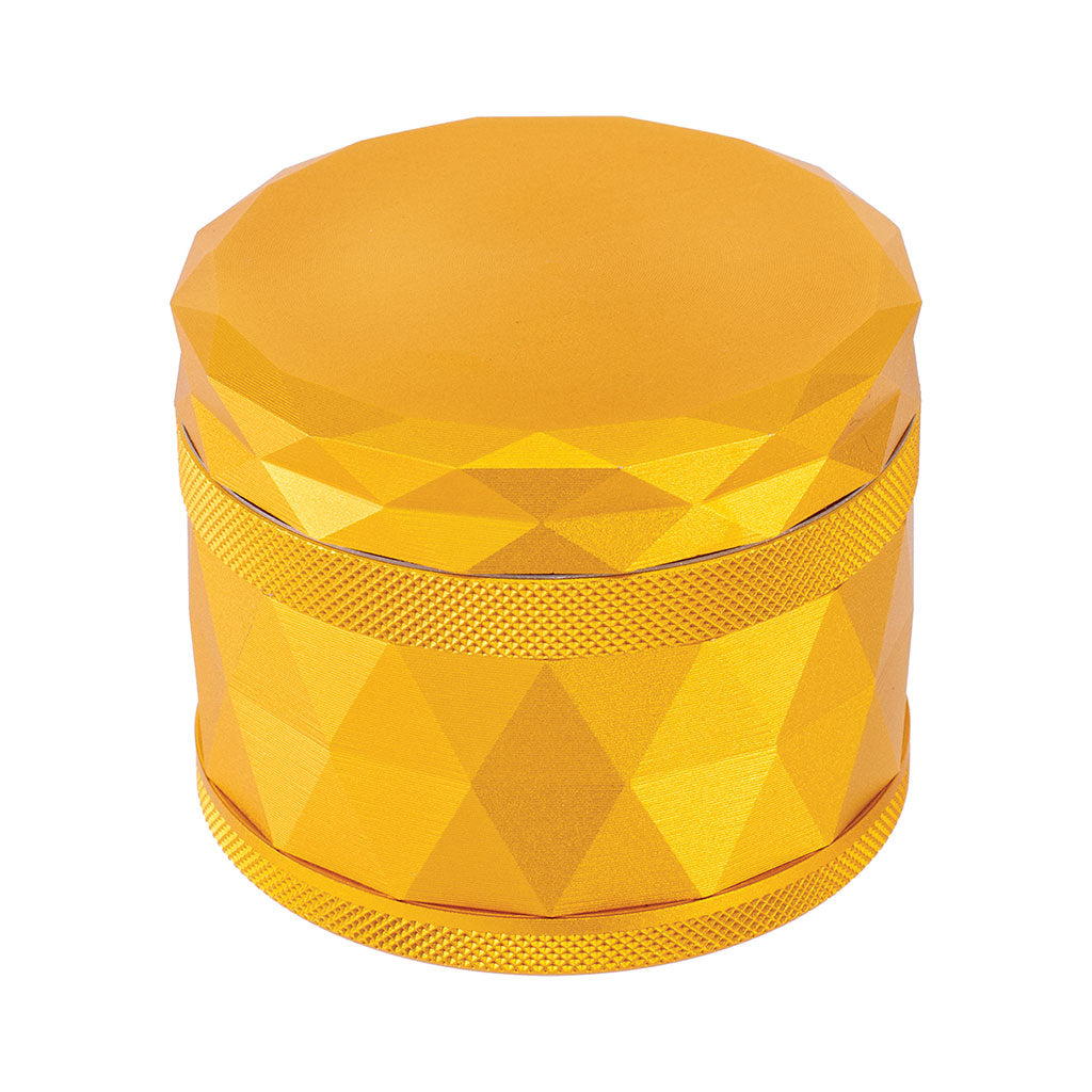 Top view of gold Harlequin Pattern Grinder with faceted aluminum design and textured grip for precise grinding 