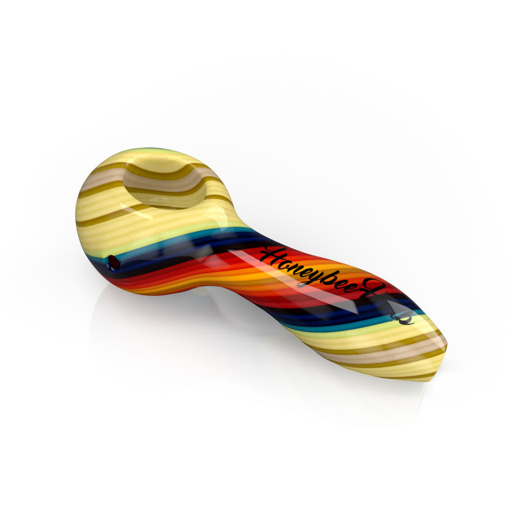 Orange twist colored vibrant linework glass spoon pipe, handcrafted design for smooth smoke.