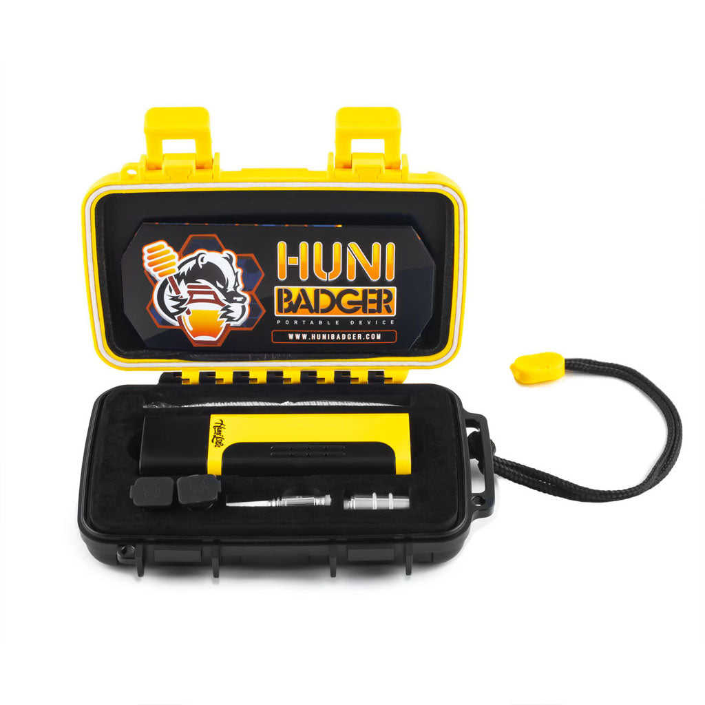 Top view of Huni Badger yellow edition kit with portable vaporizer and parts in case