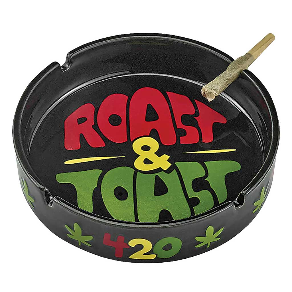 Large Roast and Toast ceramic ashtray with wide tray base, novelty text design, deep ash slots, and glossy ceramic finish