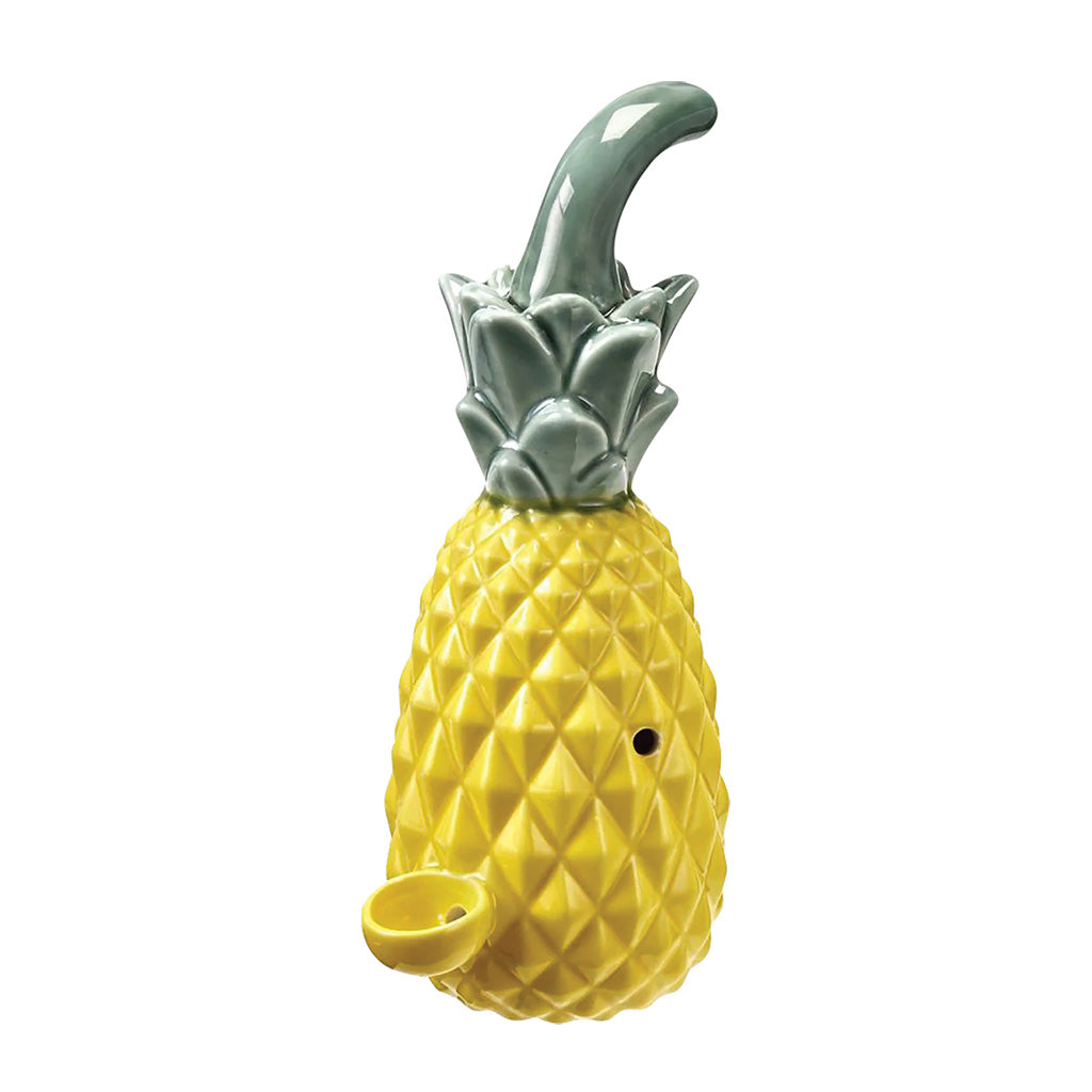 Yellow pineapple-shaped smoking pipe with textured fruit body, green leaf top, front bowl, side carb hole, and glossy finish