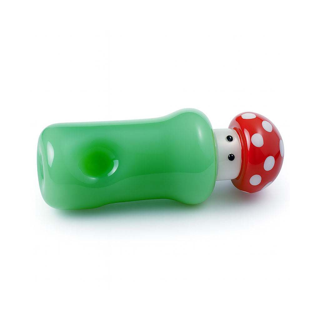 horizontal view of green mushroom glass hand pipe with red spotted cap and deep bowl, premium novelty pipe, shop honeybee herb 