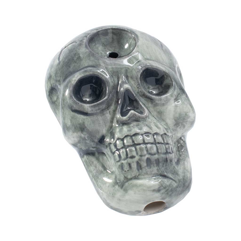 Shop skull ceramic hand pipe, angled view showing carb hole and mouthpiece—add to cart now. 