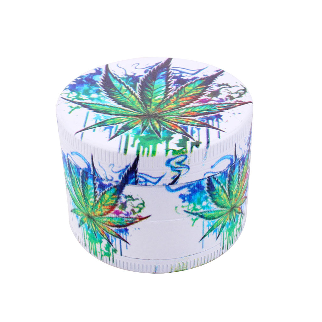 White 4-piece aluminum herb grinder with blue smoke splash artwork and green leaf design, lid view
