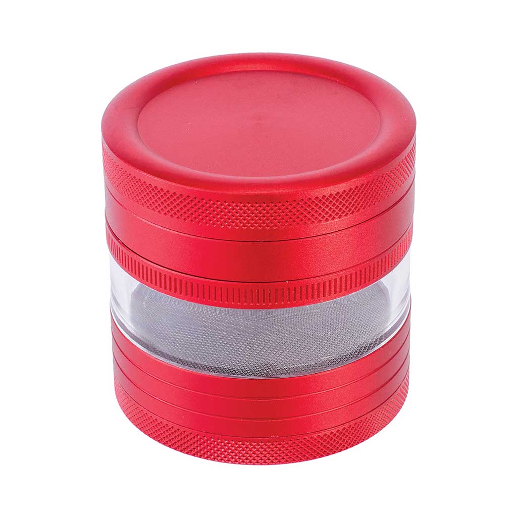 Disassembled red herb grinder showing transparent chamber and sharp teeth